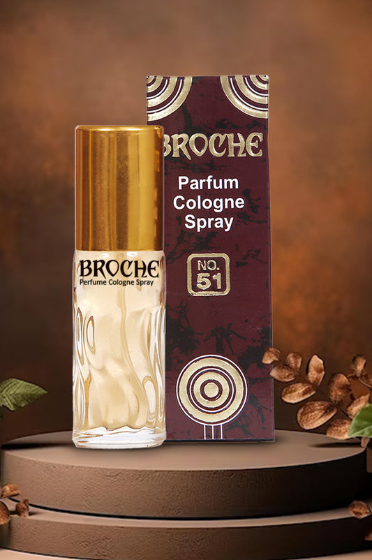 broche-51-perfume-bottle-and-packaging-on-wodden-platform-with-bown-background-and-leaves