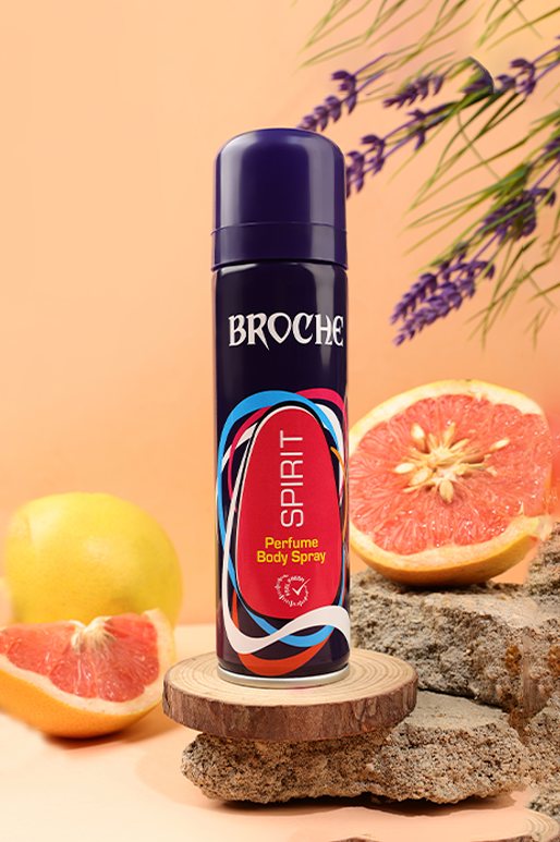 broche-body-spray-spirit-150ml-aluminum-bottle-on-rocks-with-orange-slices-and-flowers-in-the-background