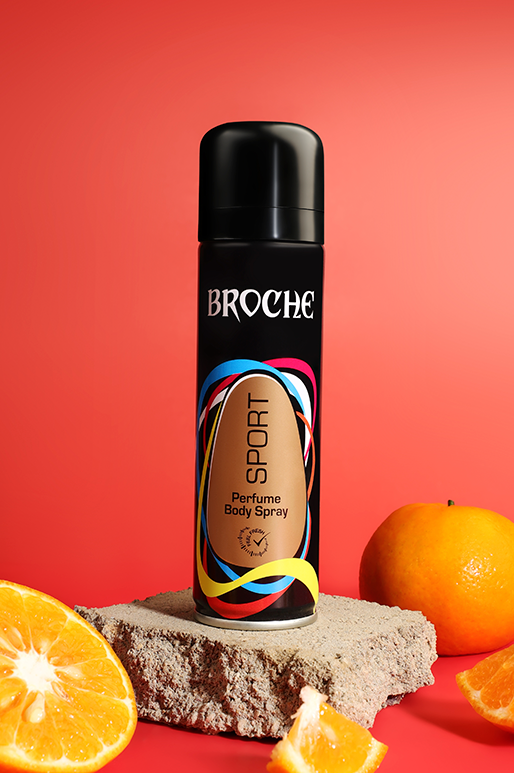 broche-body-spray-sports-150ml-aluminum-bottle-on-rocks-with-orange-slices-and-red-background