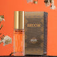 broche-oud-perfume-15ml-with-bottle-and-packaging-on-rock-with-orange-background-and-flowers